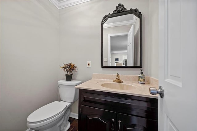 bathroom featuring vanity, crown molding, wood-type flooring, and toilet