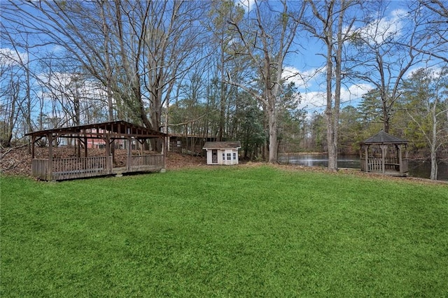 5422 Hill Rd SW, Powder Springs, GA 30127 - view of grassy yard featuring a gazebo, an outbuilding, a storage shed, and a water view