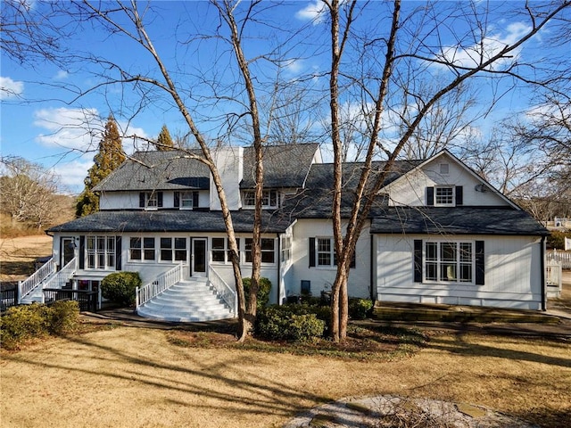 rear view of house with a lawn