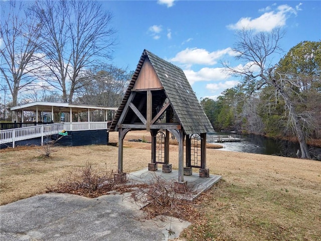 view of community with a water view and a yard