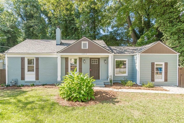 1404 E Forrest Ave, Atlanta, GA 30344 - view of front facade with a front yard, a chimney, fence, brick siding, and roof with shingles