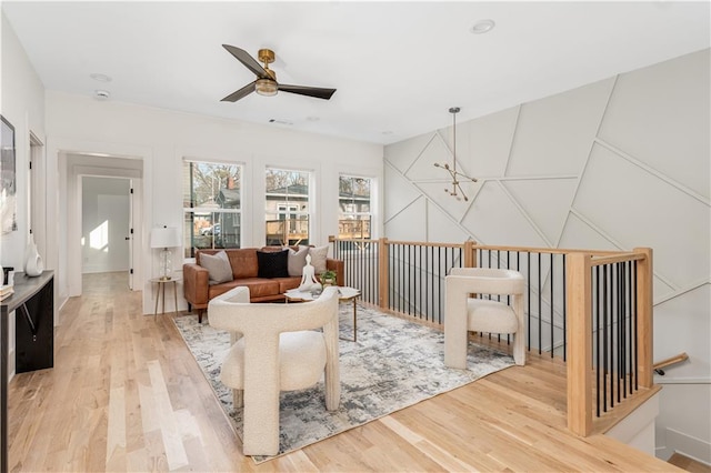 living room with ceiling fan and wood finished floors