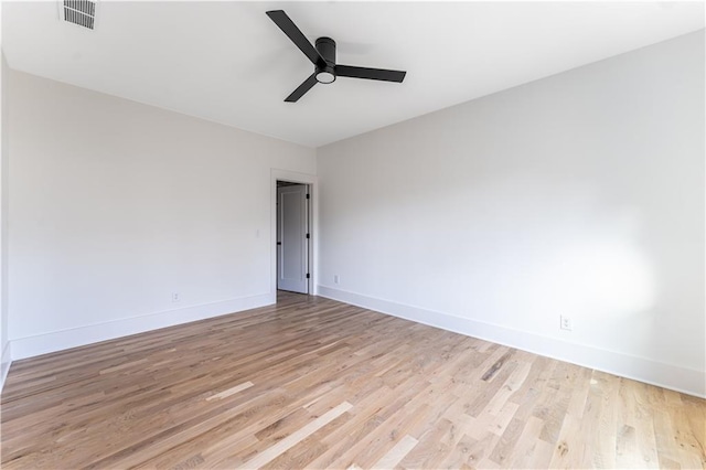 unfurnished room with visible vents, baseboards, light wood-style flooring, and a ceiling fan