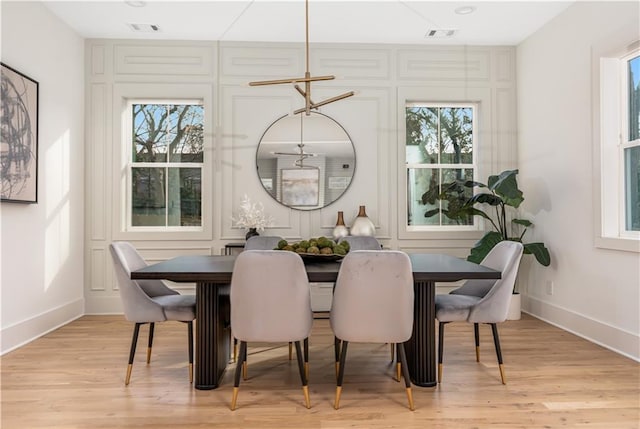 dining area with visible vents, plenty of natural light, and light wood-type flooring