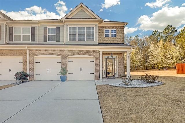 view of front of home with brick siding, concrete driveway, and a garage