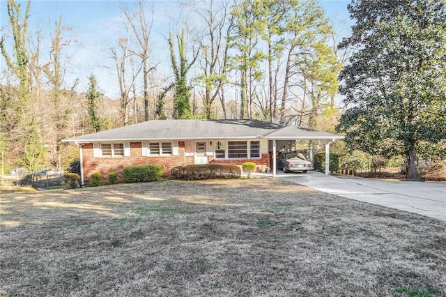 ranch-style house with a front yard and a carport