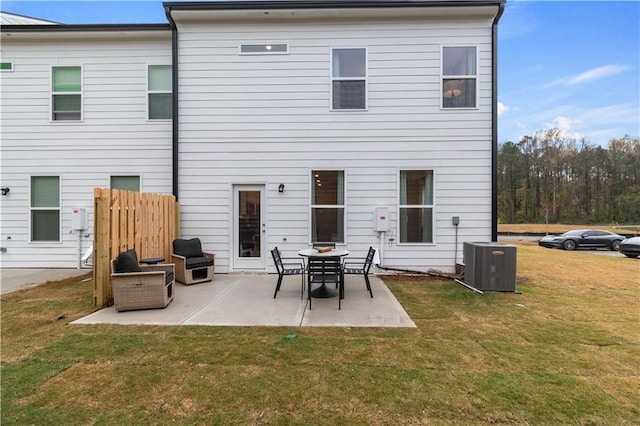 rear view of house with a patio, a lawn, and cooling unit