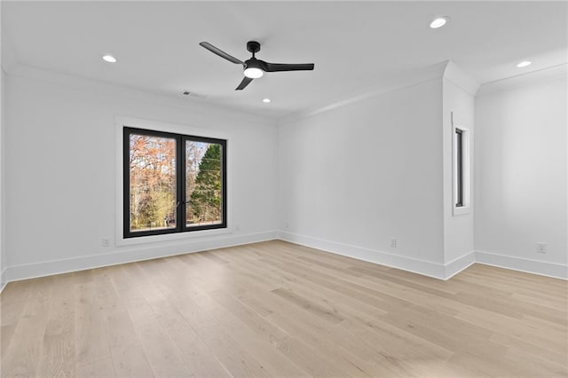 spare room with crown molding, light hardwood / wood-style flooring, and ceiling fan