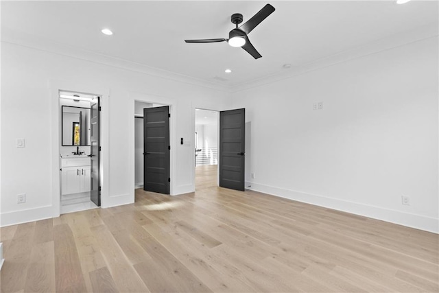 unfurnished bedroom featuring ensuite bath, ceiling fan, sink, light hardwood / wood-style flooring, and ornamental molding