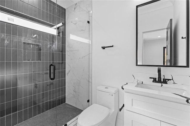 bathroom with vanity, toilet, and an enclosed shower