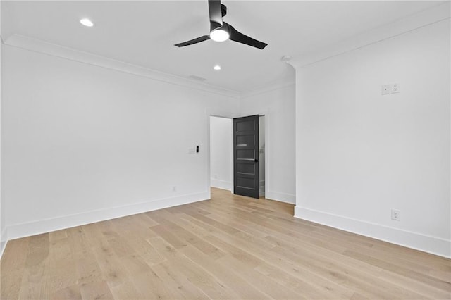 empty room featuring light hardwood / wood-style flooring, ceiling fan, and crown molding