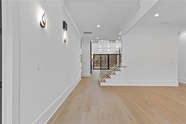 hallway with beamed ceiling and light wood-type flooring