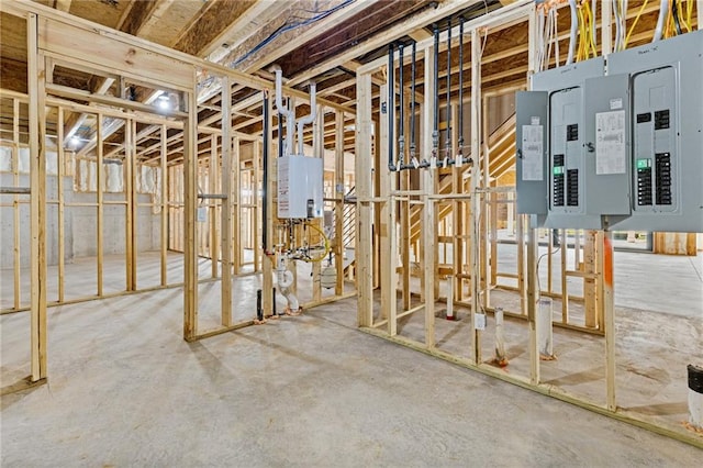 basement featuring electric panel and water heater