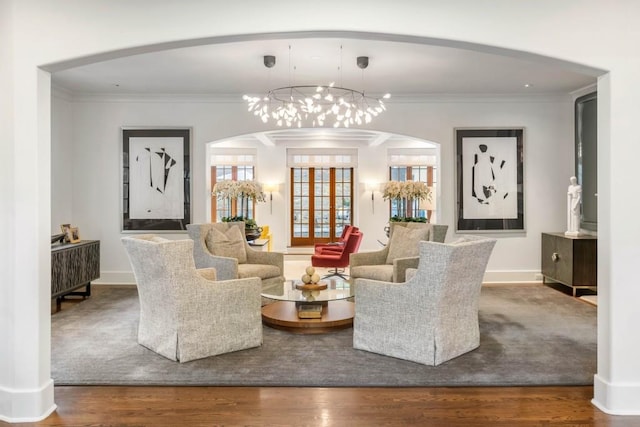 interior space with baseboards, wood finished floors, and crown molding