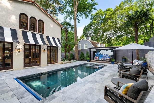 view of pool featuring a patio, an outdoor hangout area, fence, french doors, and a pool with connected hot tub