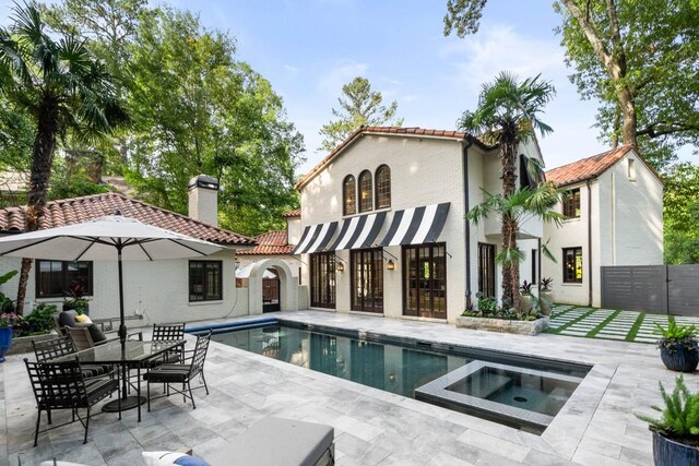 mediterranean / spanish-style house with a garage and a front lawn