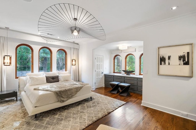 bedroom featuring crown molding, multiple windows, and dark wood-type flooring