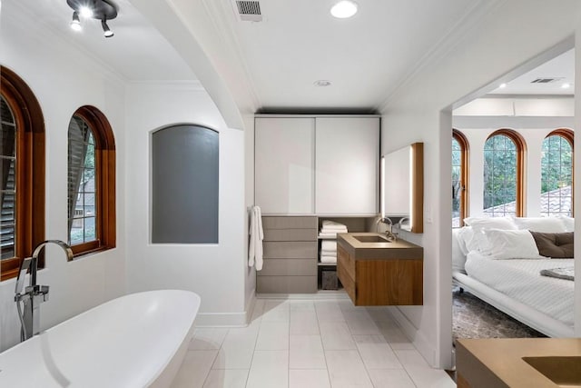 full bathroom featuring visible vents, ensuite bath, ornamental molding, vanity, and a freestanding tub