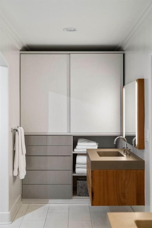 bathroom featuring ornamental molding, tile patterned flooring, and vanity