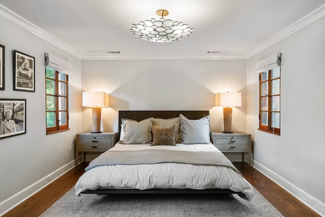 bedroom with dark wood-style floors, visible vents, crown molding, and baseboards