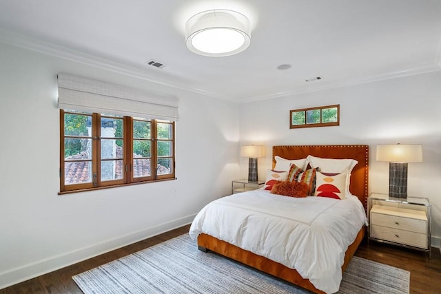 bedroom with dark wood-style floors, visible vents, baseboards, and multiple windows