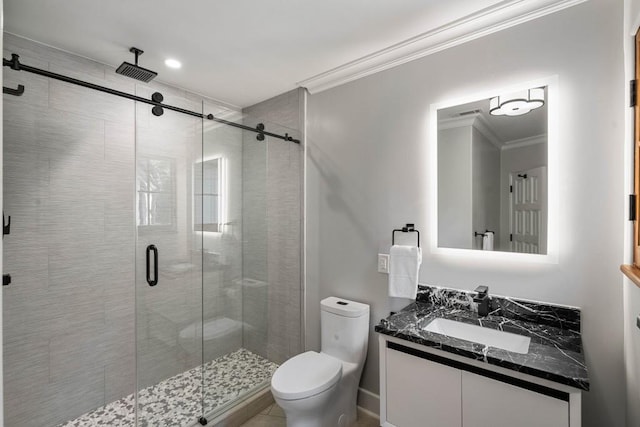 full bathroom featuring vanity, ornamental molding, a shower stall, and toilet