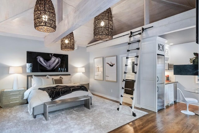 bedroom featuring baseboards, stainless steel built in refrigerator, wood finished floors, and beamed ceiling