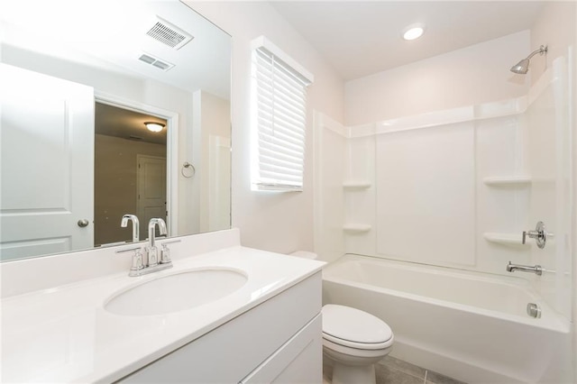 full bathroom featuring toilet, washtub / shower combination, tile patterned flooring, and vanity