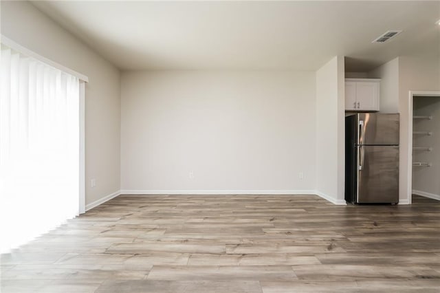 spare room featuring light hardwood / wood-style flooring