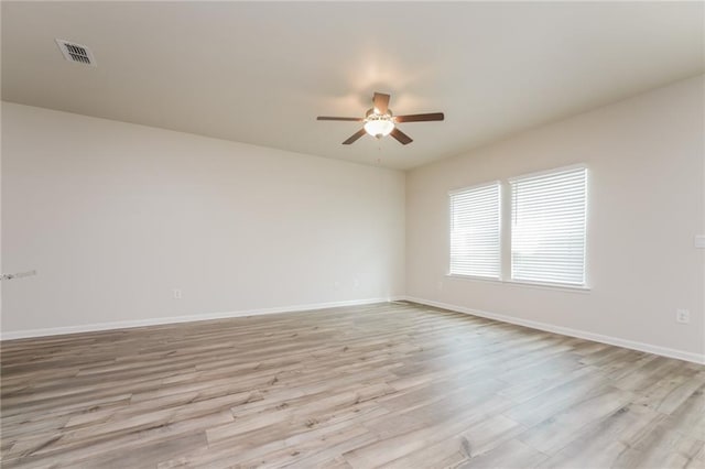 empty room with light wood-type flooring and ceiling fan