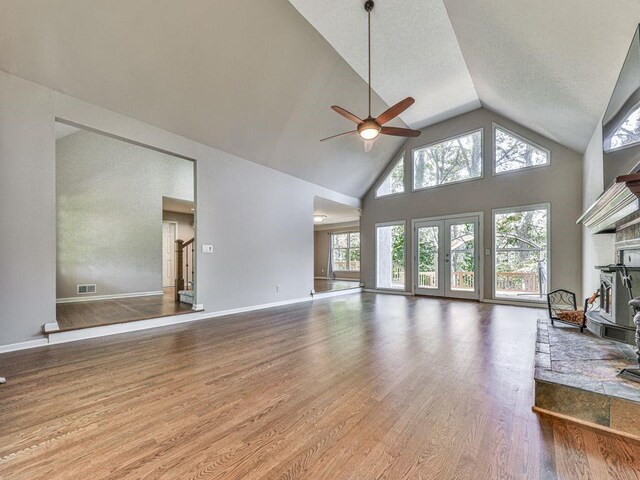 living room featuring ceiling fan, high vaulted ceiling, and wood-type flooring