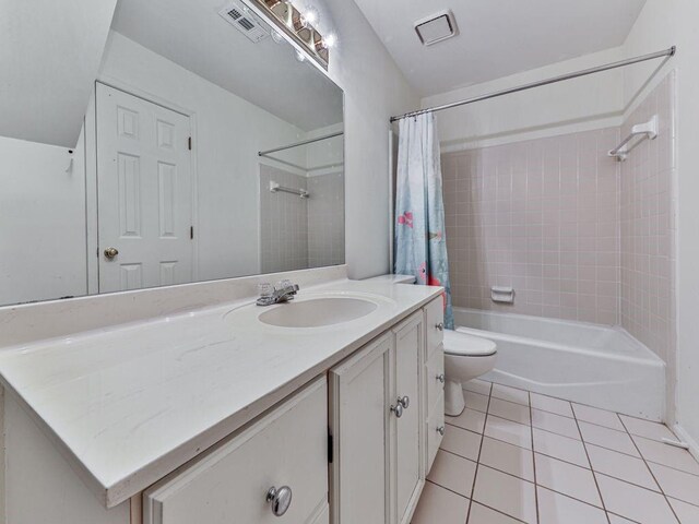 full bathroom with tile patterned flooring, vanity, shower / tub combo, and toilet