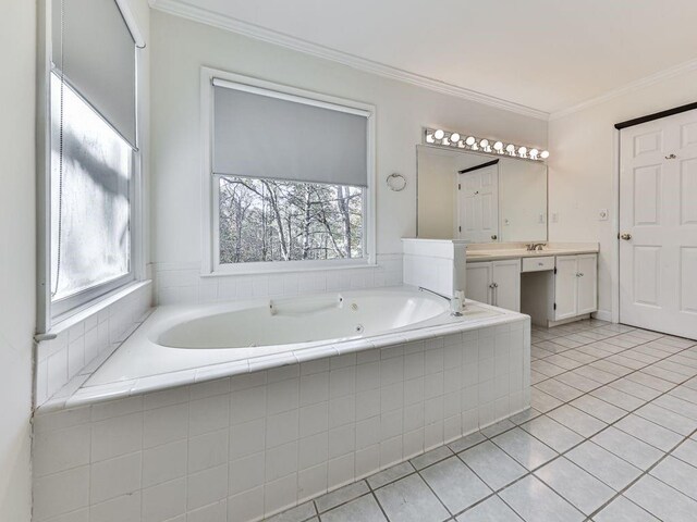 bathroom with tile patterned flooring, vanity, crown molding, and tiled tub