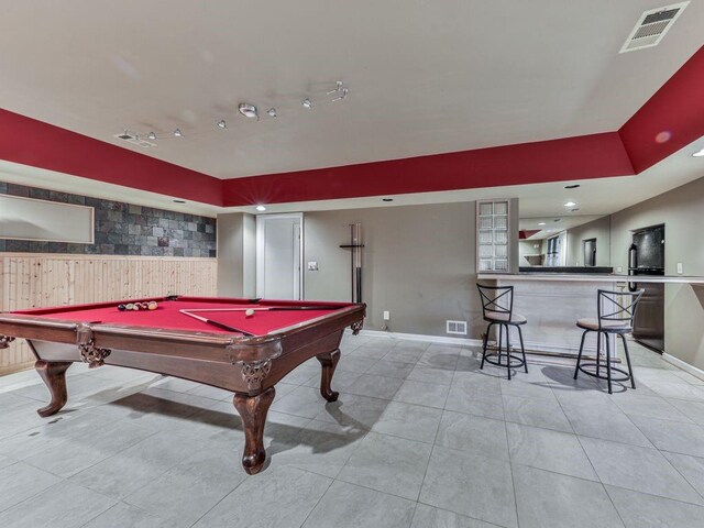 game room featuring bar, light tile patterned floors, and billiards