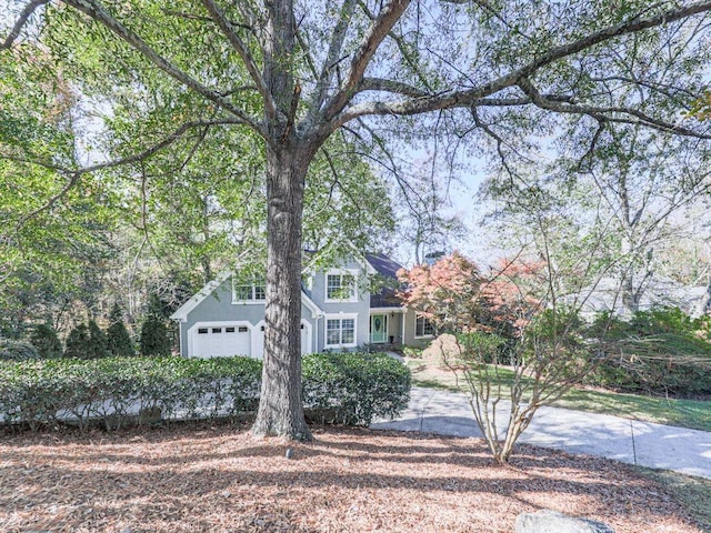 obstructed view of property with a garage