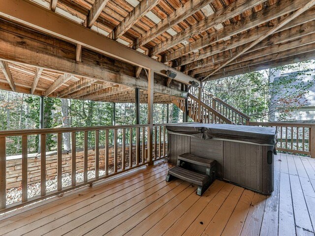 wooden deck with a hot tub