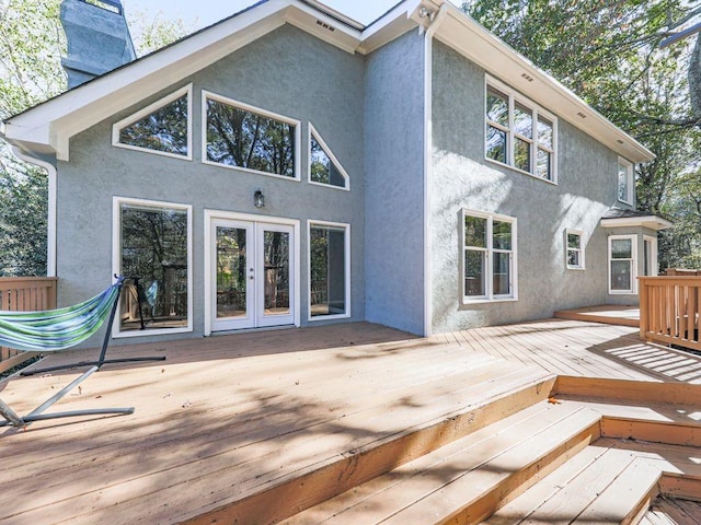 back of property featuring a deck and french doors