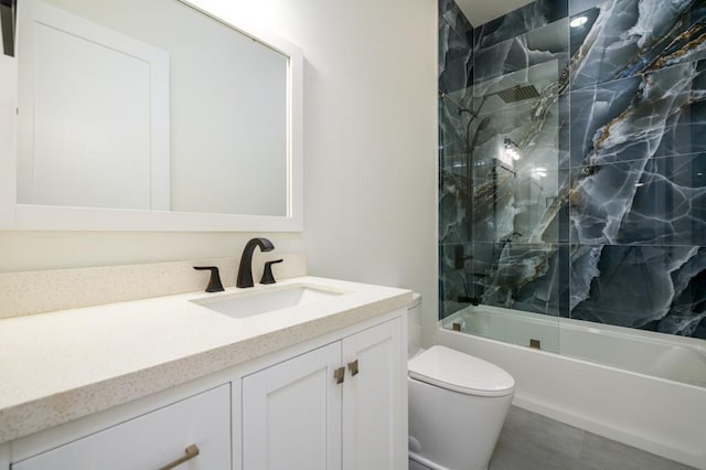 full bathroom with vanity, tiled shower / bath combo, and toilet