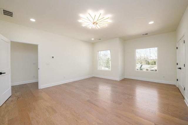 spare room featuring light hardwood / wood-style flooring