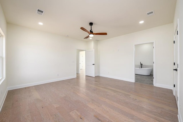 unfurnished bedroom with ceiling fan, connected bathroom, and light hardwood / wood-style floors