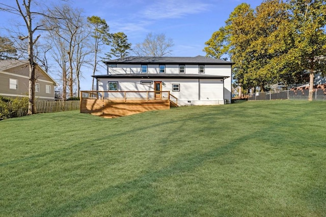 back of property featuring a deck and a lawn