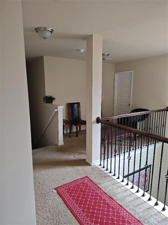 corridor with carpet flooring