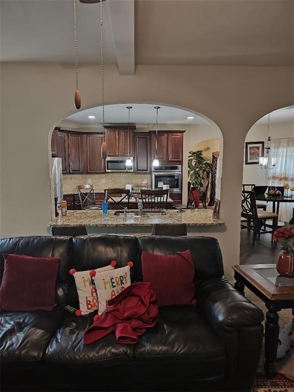 living room featuring beam ceiling