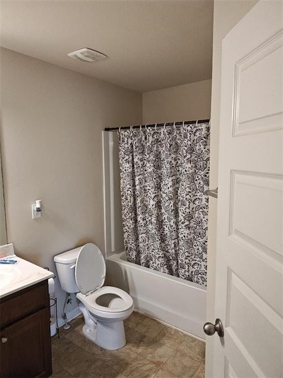 full bathroom with shower / bath combo, toilet, and vanity