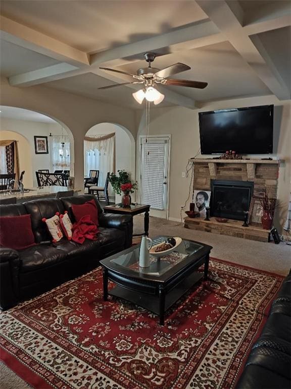 carpeted living room featuring beam ceiling, ceiling fan, a fireplace, and coffered ceiling