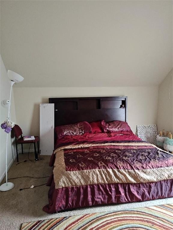 carpeted bedroom featuring lofted ceiling