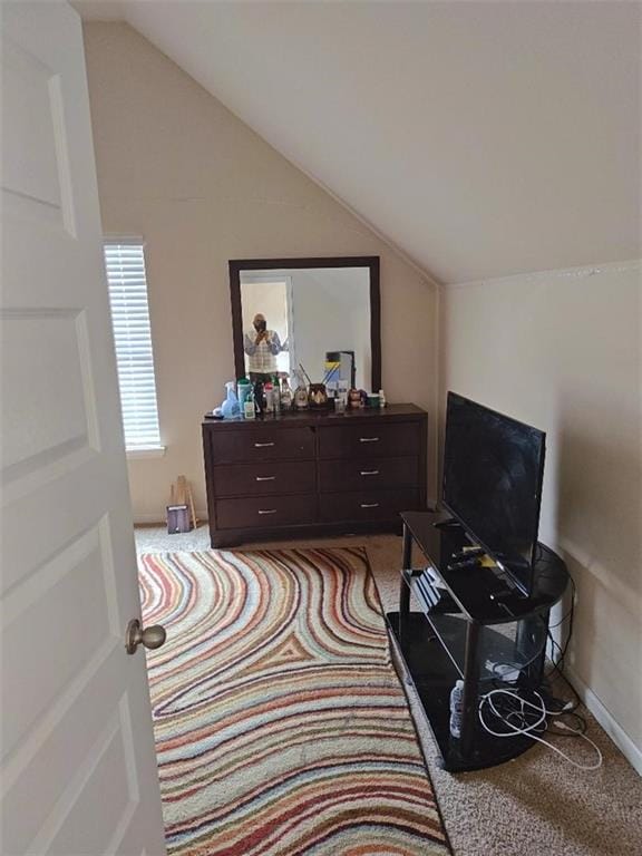 living area with light carpet and vaulted ceiling