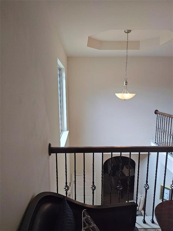 staircase featuring a raised ceiling