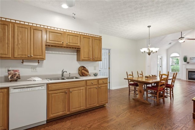 kitchen with sink, dishwasher, hanging light fixtures, a textured ceiling, and dark hardwood / wood-style flooring