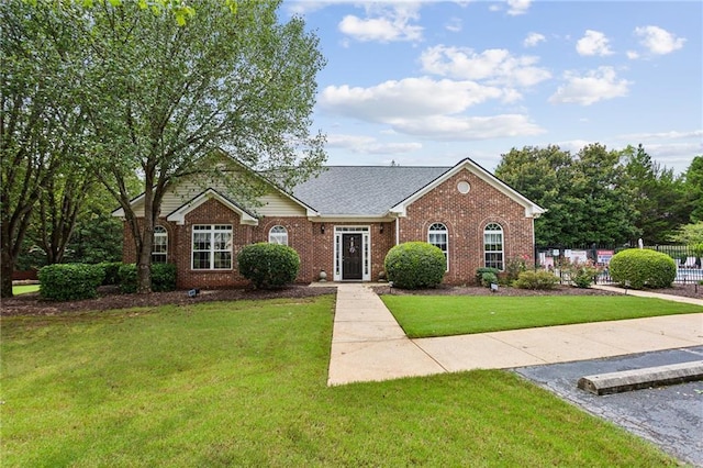 ranch-style home with a front lawn